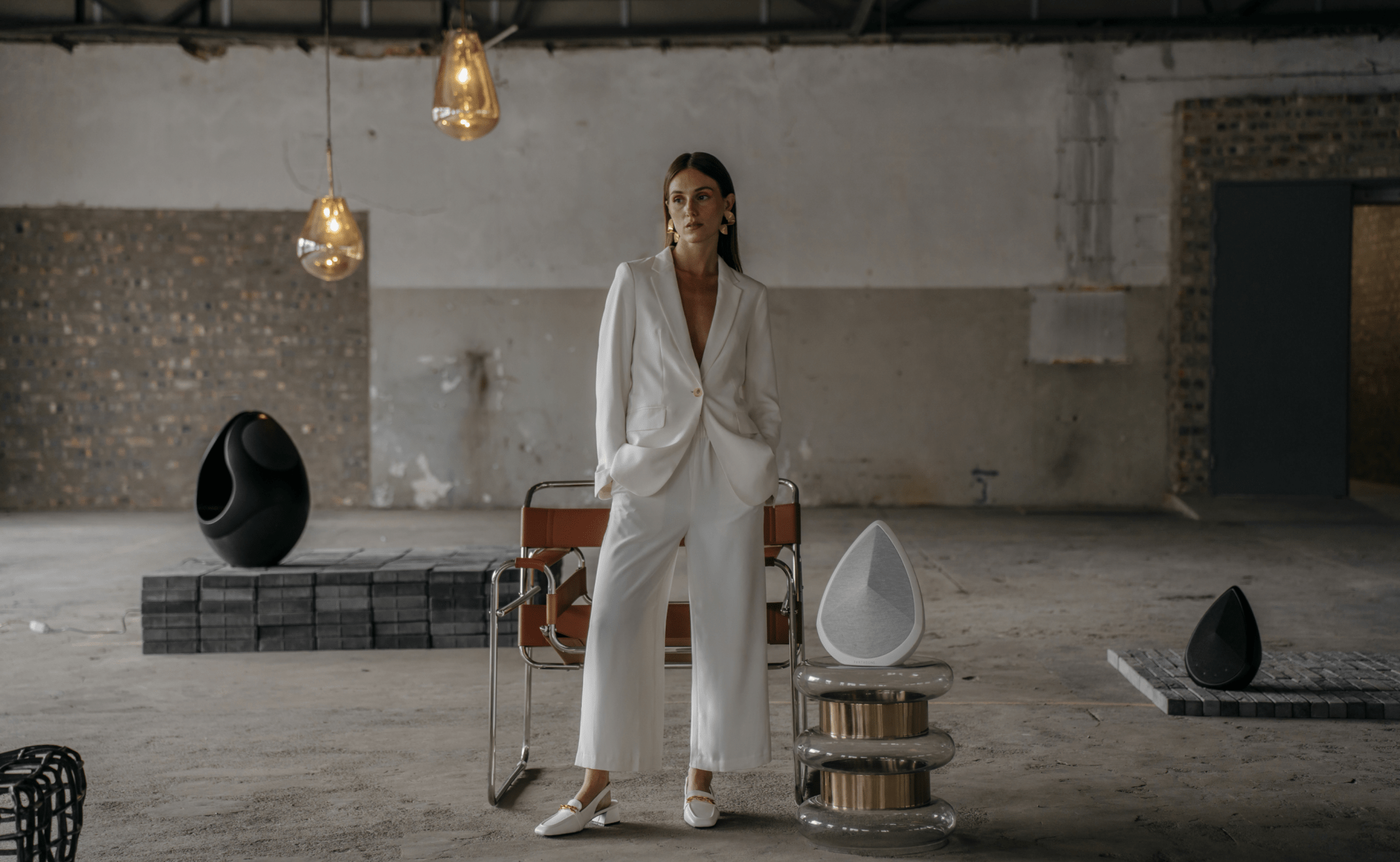 pantheone high-end wireless speakers in an industrial space with stylish light above