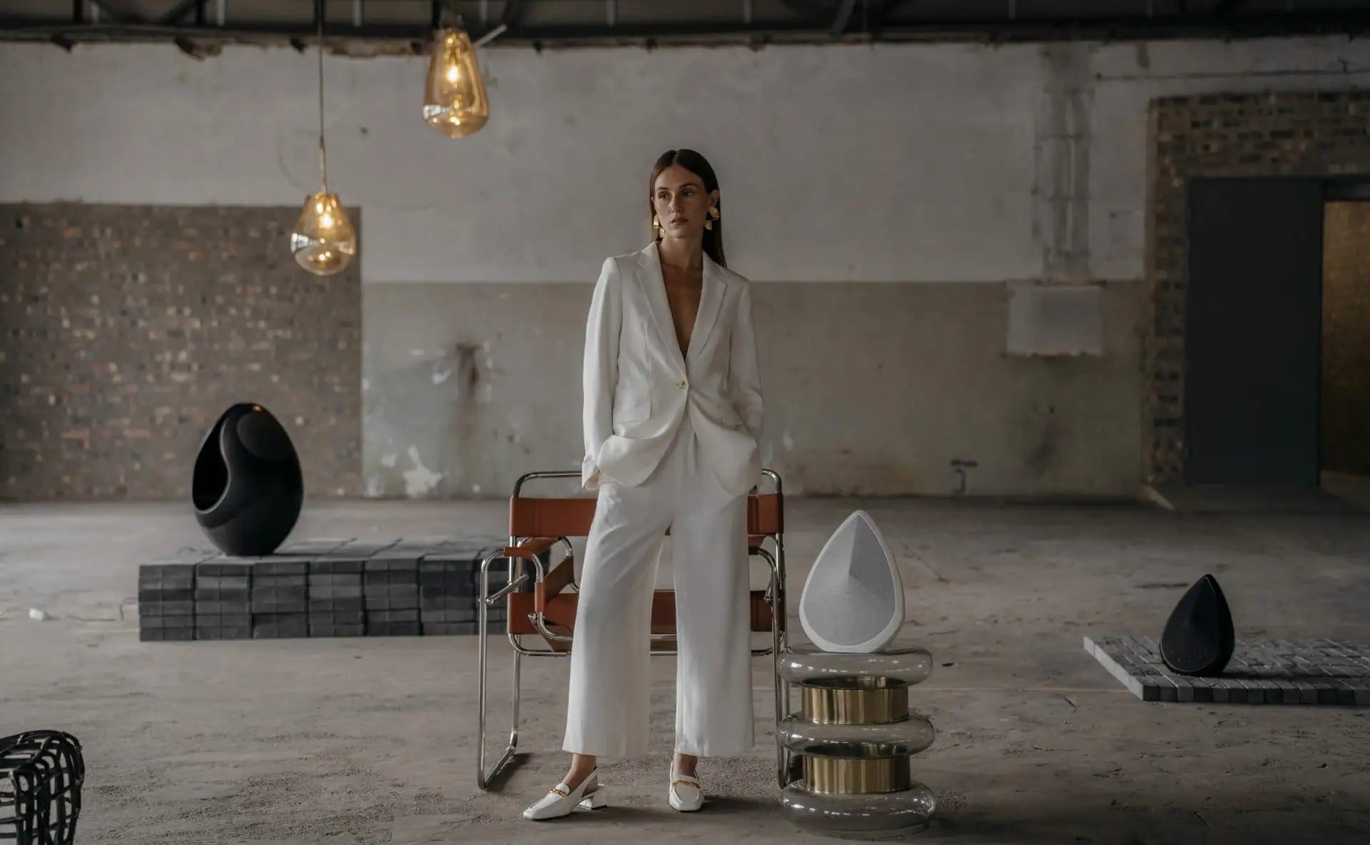 pantheone high-end wireless speakers in an industrial space with stylish light above