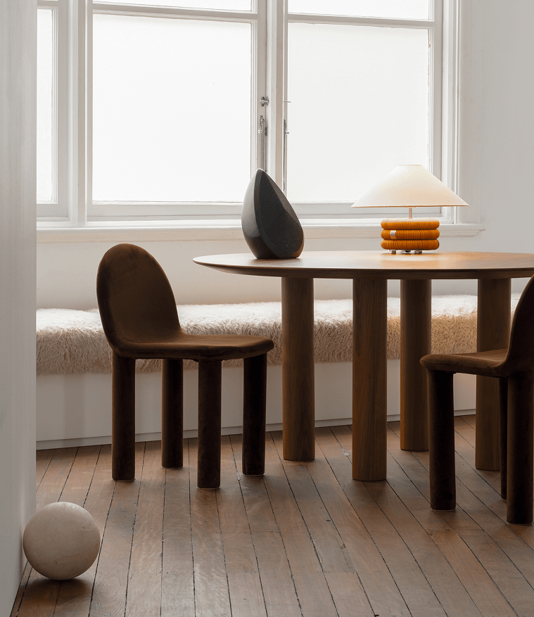Obsidian black wireless speaker on a table in curated interior