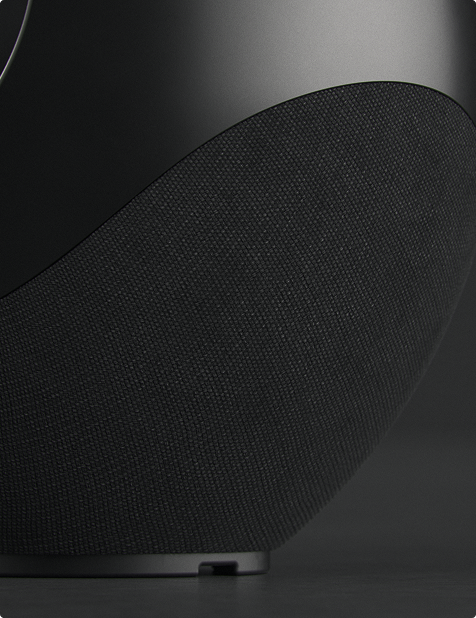 Pantheone I speaker detail showing black acoustic fabric and matte sculptural surface