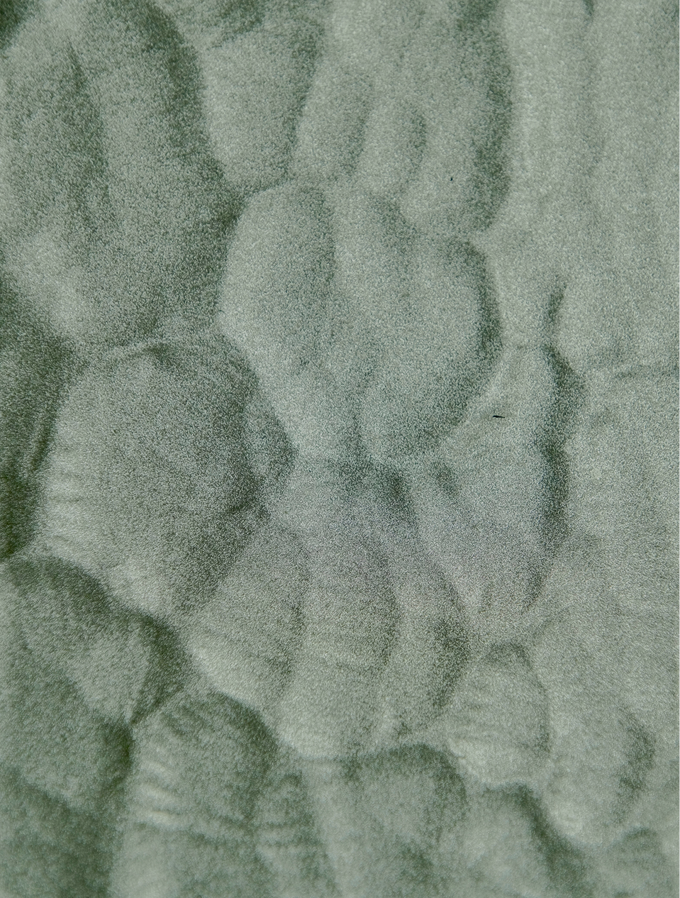 Textured green fabric pattern