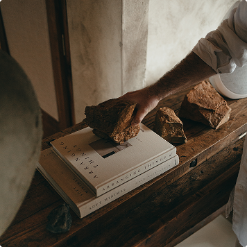 a man placing a stone on a book
