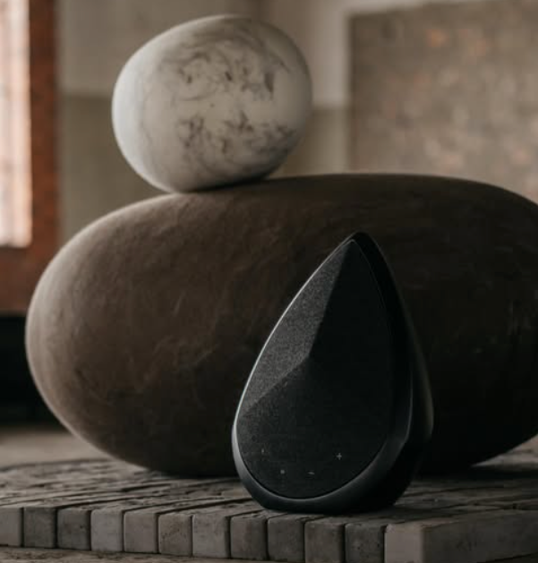 Obsidian speaker next to a rock