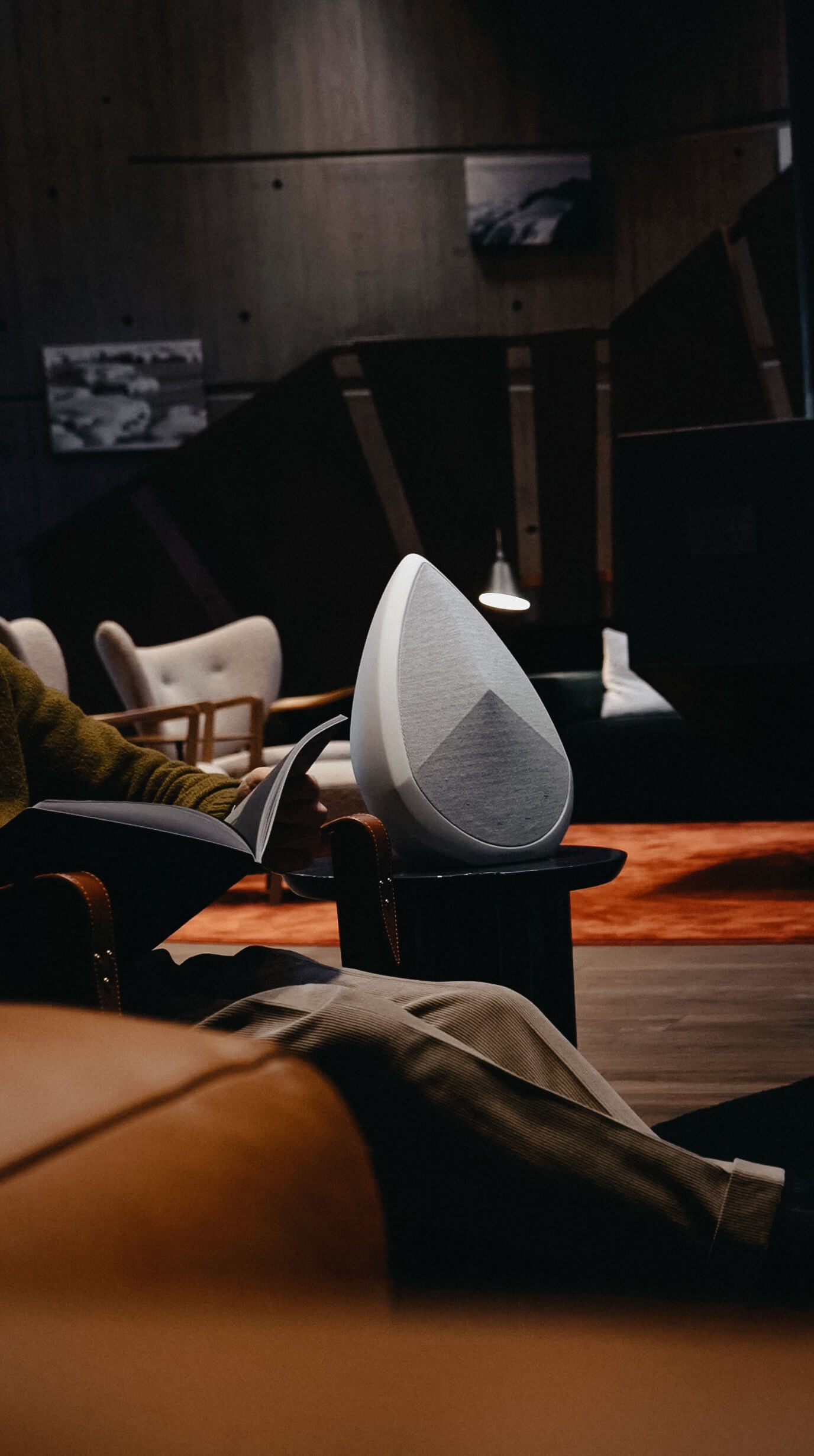 An obsidian Bluetooth speaker on a side table in a luxury hotel 