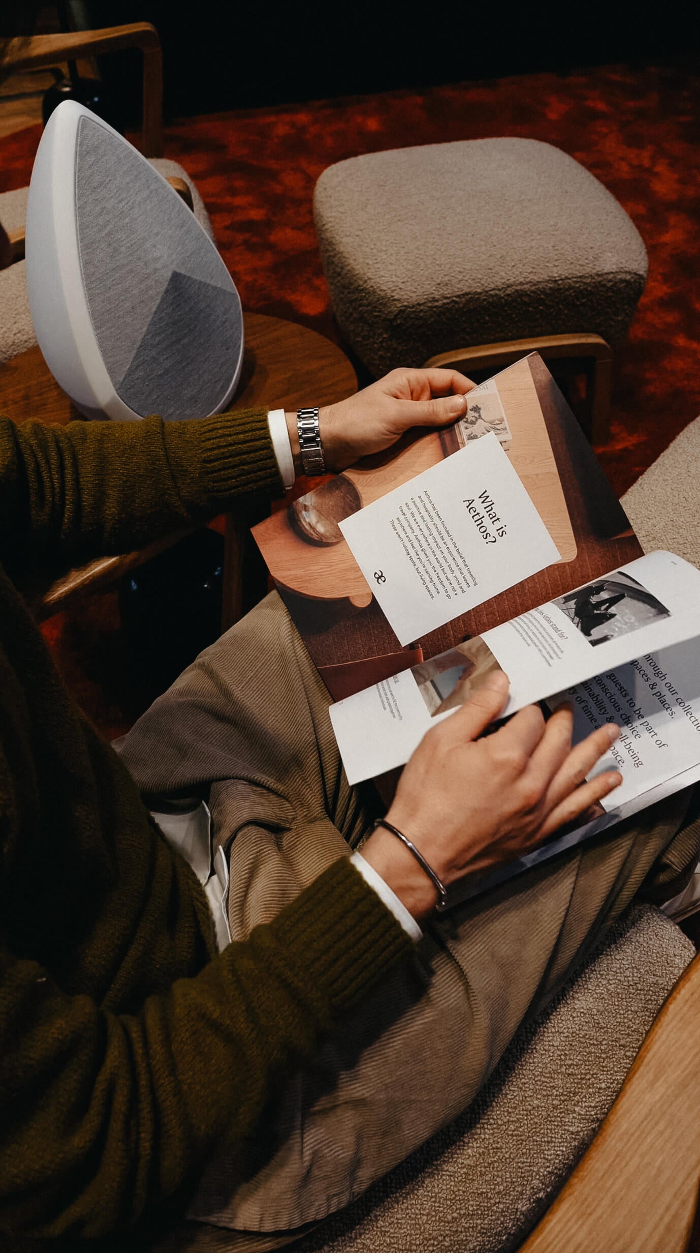 a man reading a magazine and listening to the music playing from the Obsidian wireless speaker 