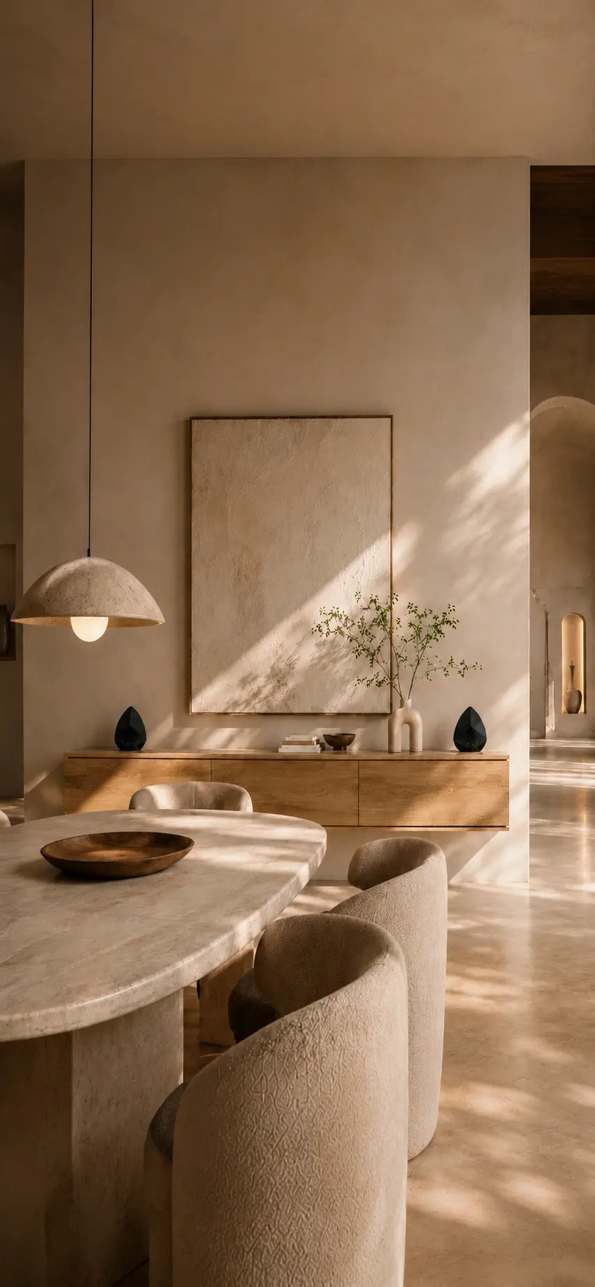 Modern interior with a dining table and chairs in a neutral color palette.
