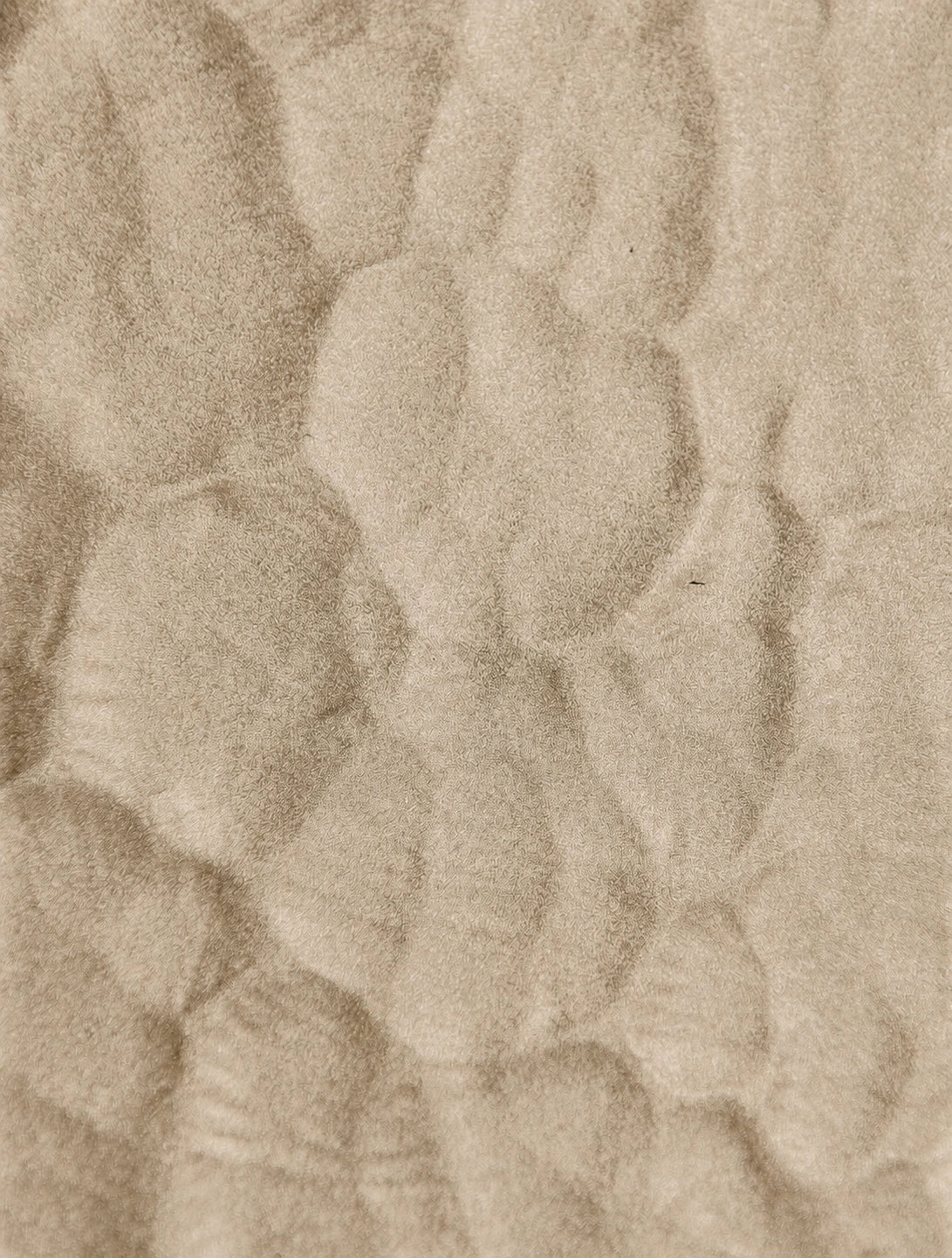 Close-up of textured beige sand pattern