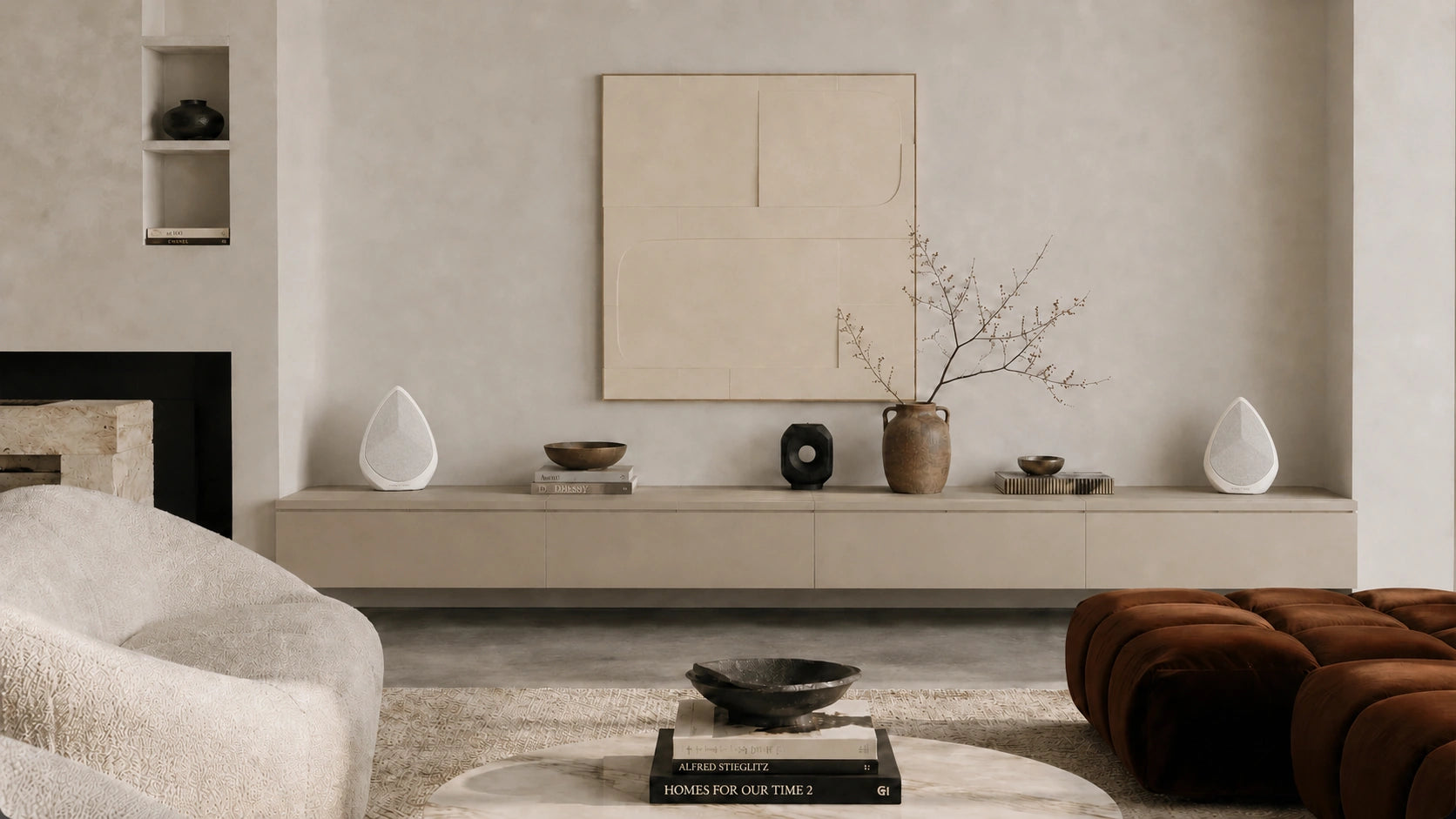 Modern living room with neutral color palette, furniture, and Obsidian wireless speakers.