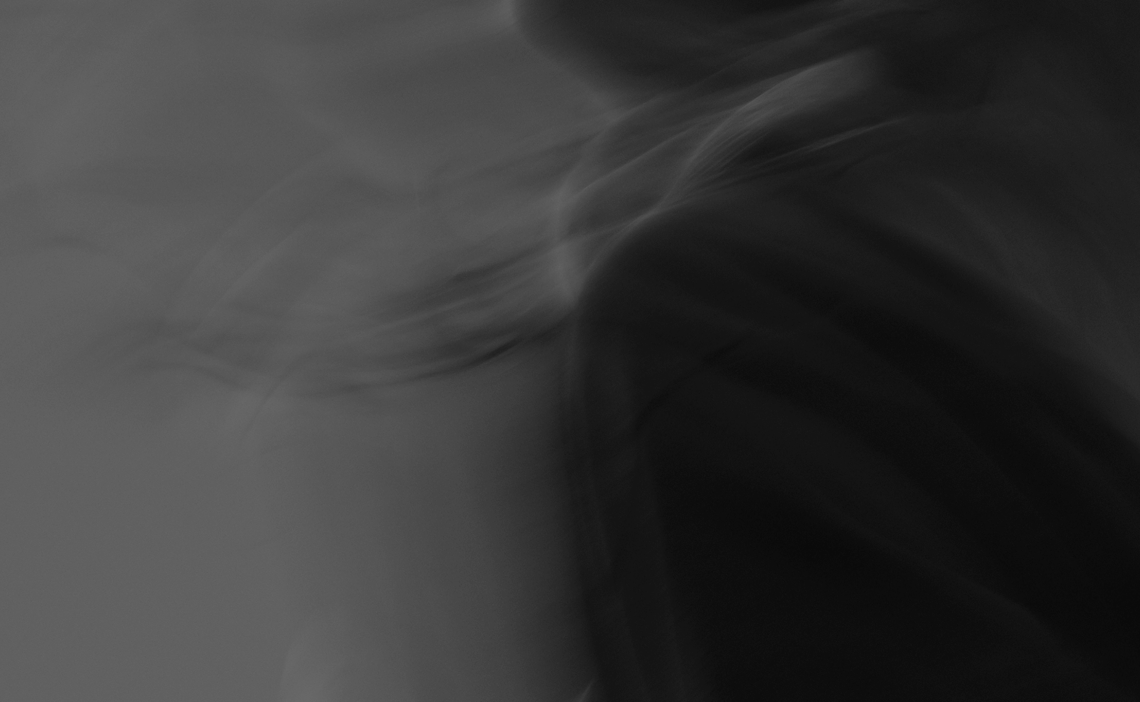 Abstract black and grey motion blur representing the flow and energy of sound.