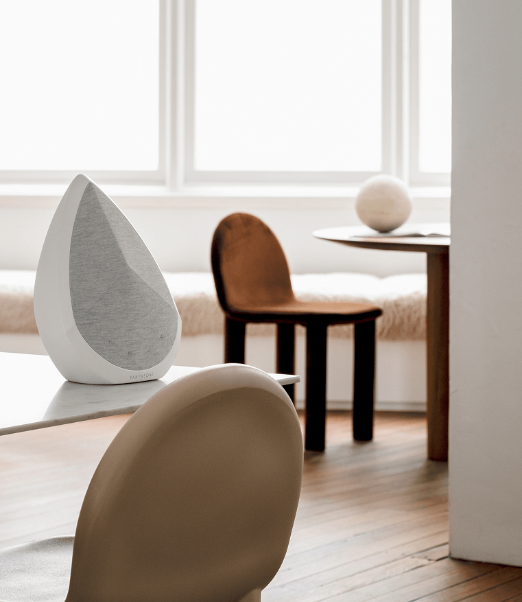 Obsidian white portable wifi speaker on a table 