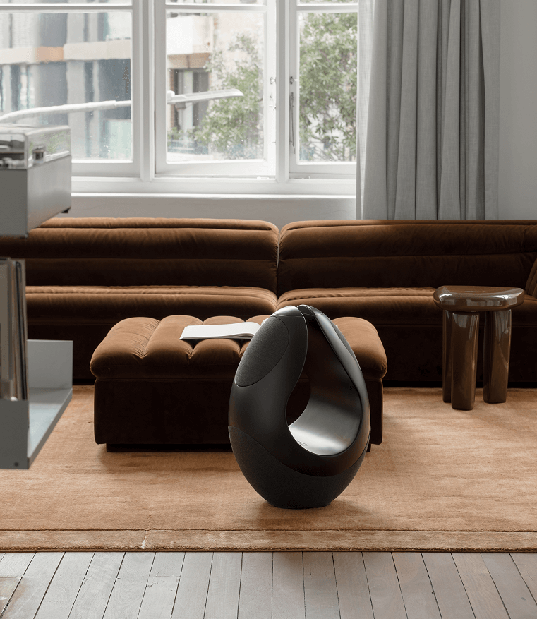 Pantheone I black wireless speaker in daylight-filled modern living room