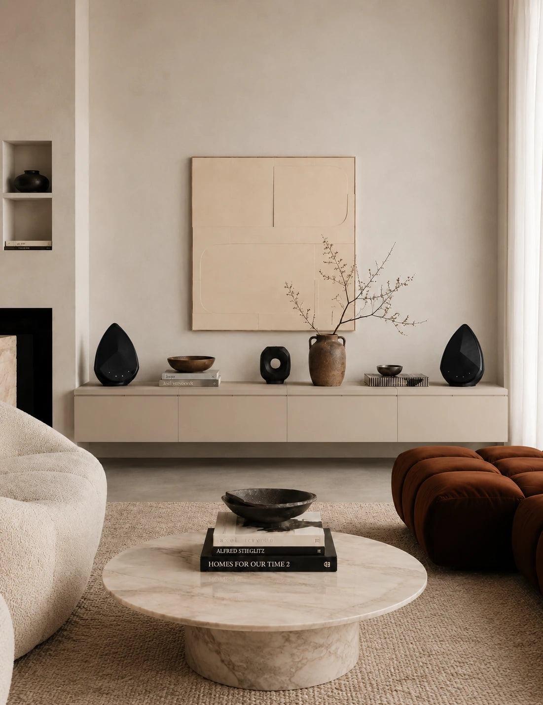 Modern living room with a neutral color palette, featuring a coffee table, sofa, and decorative items.