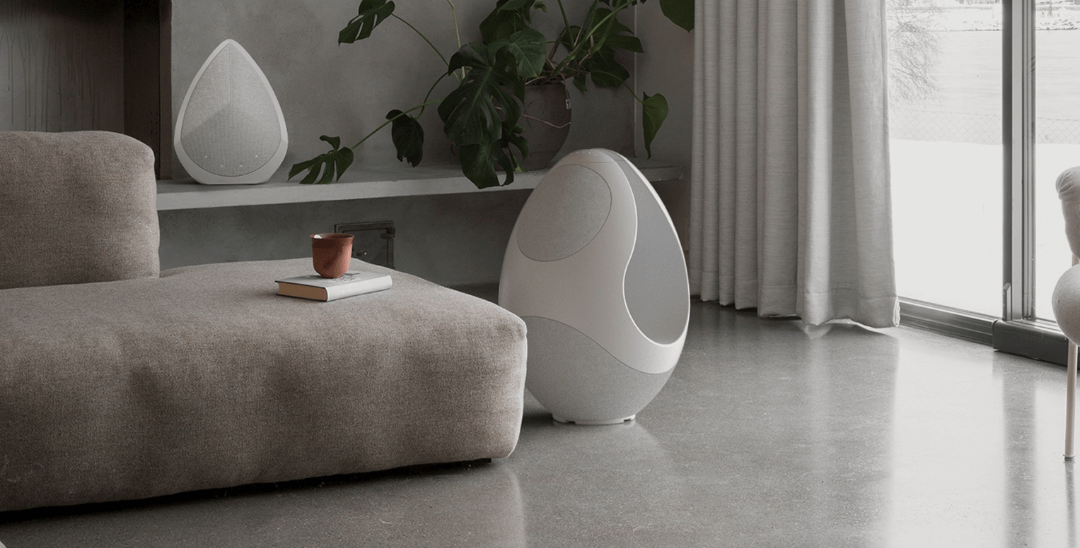 Pantheone I and Obsidian designer speakers in a modern living room with bright light 