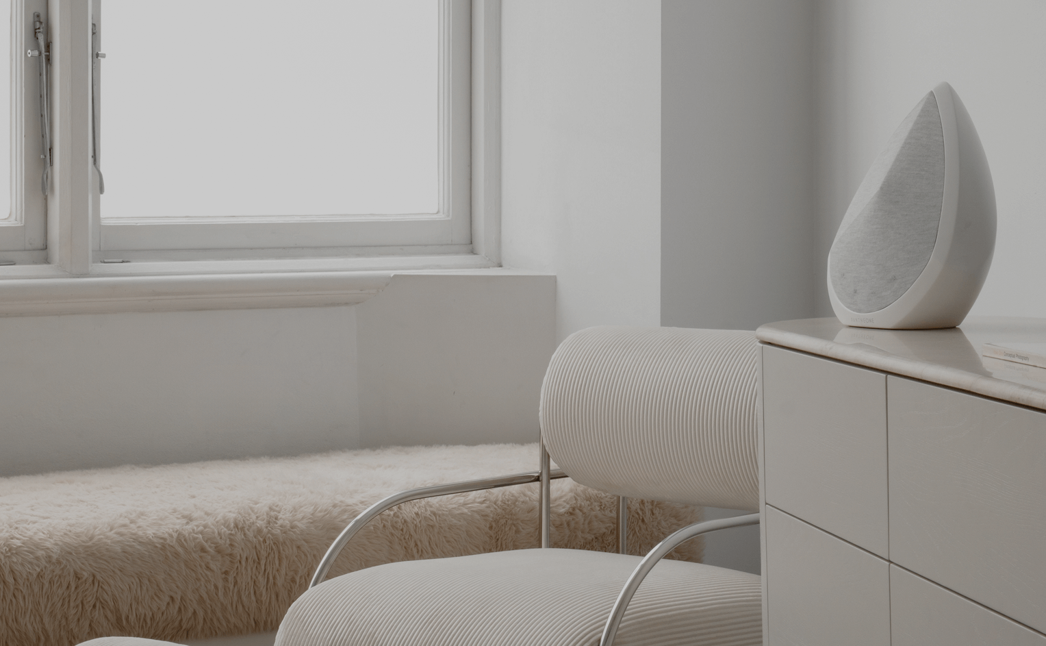 obsidian wifi speaker on a cabinet in a bedroom 