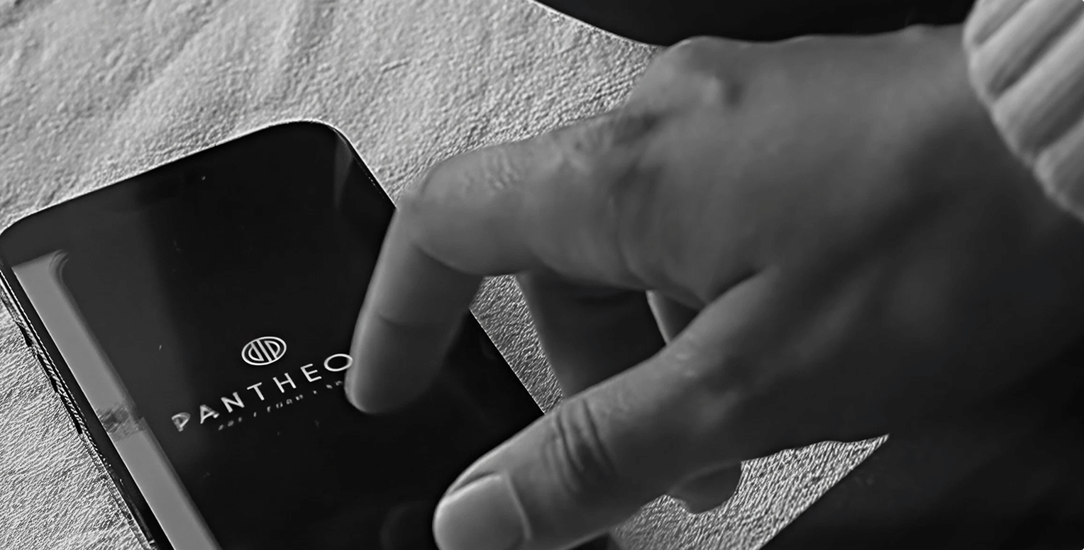 a hand reaching to iPhone while the Pantheon App open