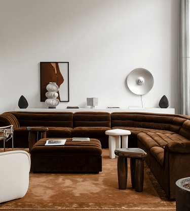 Two Pantheone Obsidian wireless speakers demonstrating stereo listening in a modern living room 