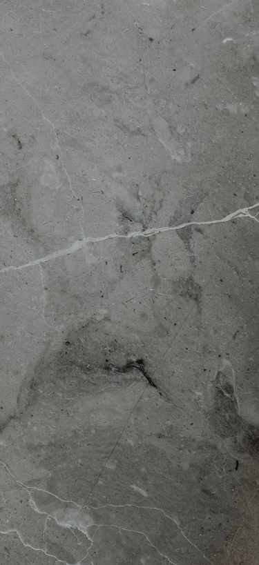 Close-up of grey marble surface with natural veining and subtle cracks.