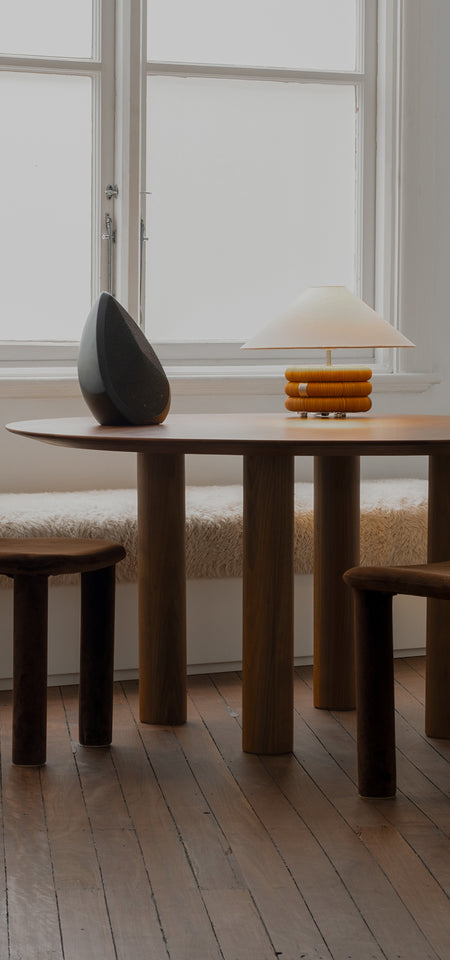 Obsidian black wireless speaker with minimalist sculptural design