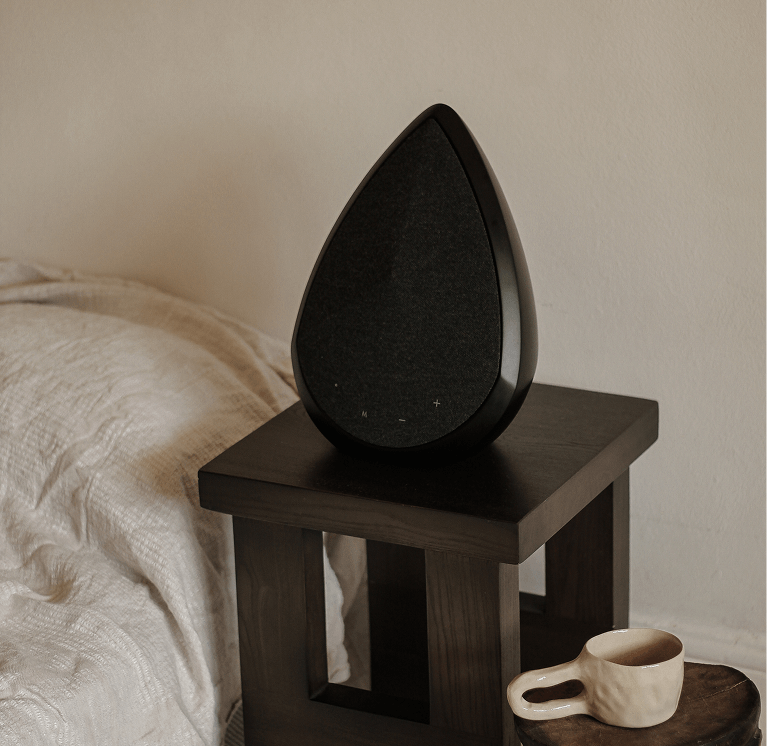 Obsidian Bluetooth speaker on a bedside table