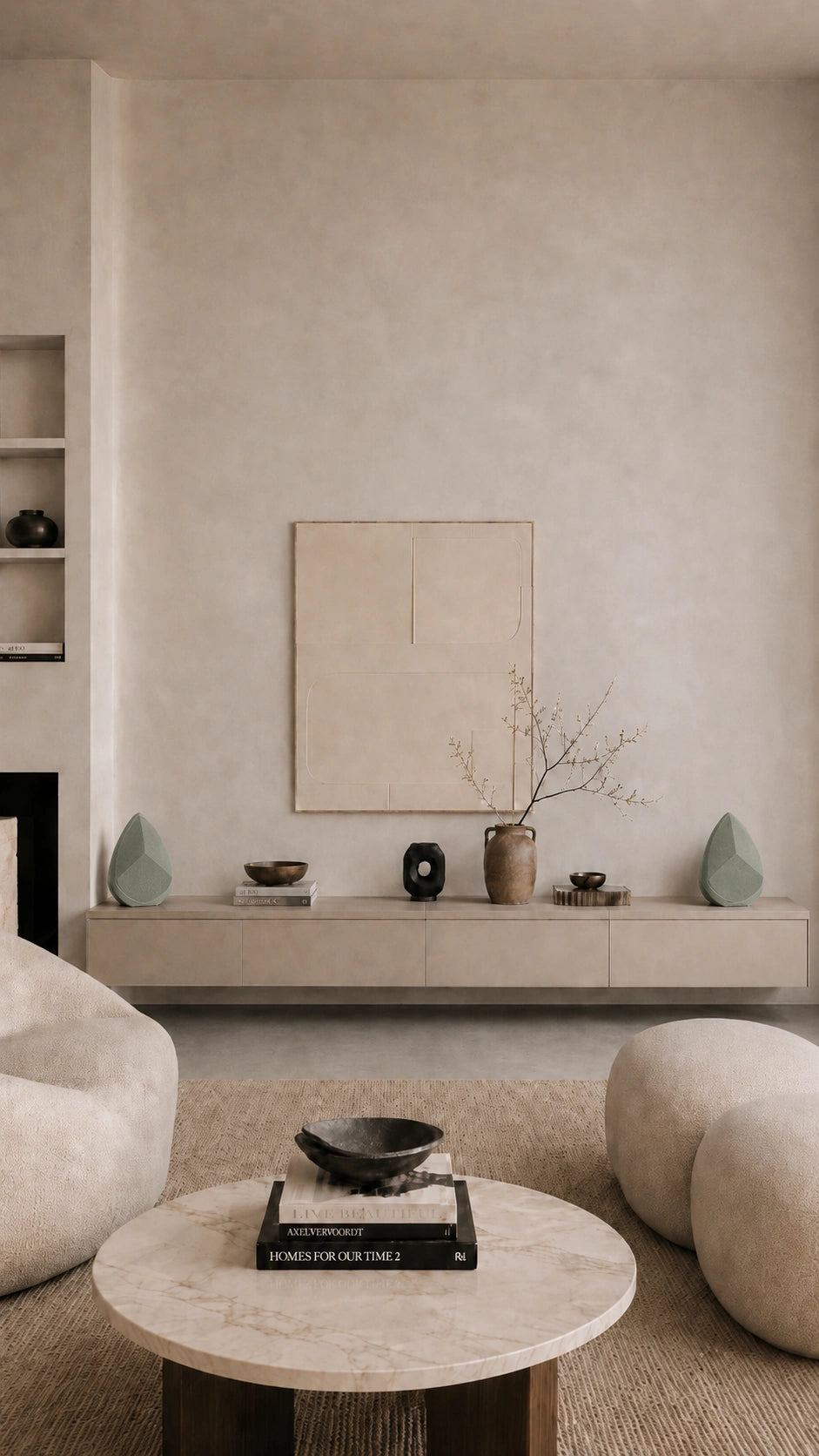 Modern living room with neutral decor, round coffee table, and wall art and the two Obsidian sage speakers on a cabinet. 