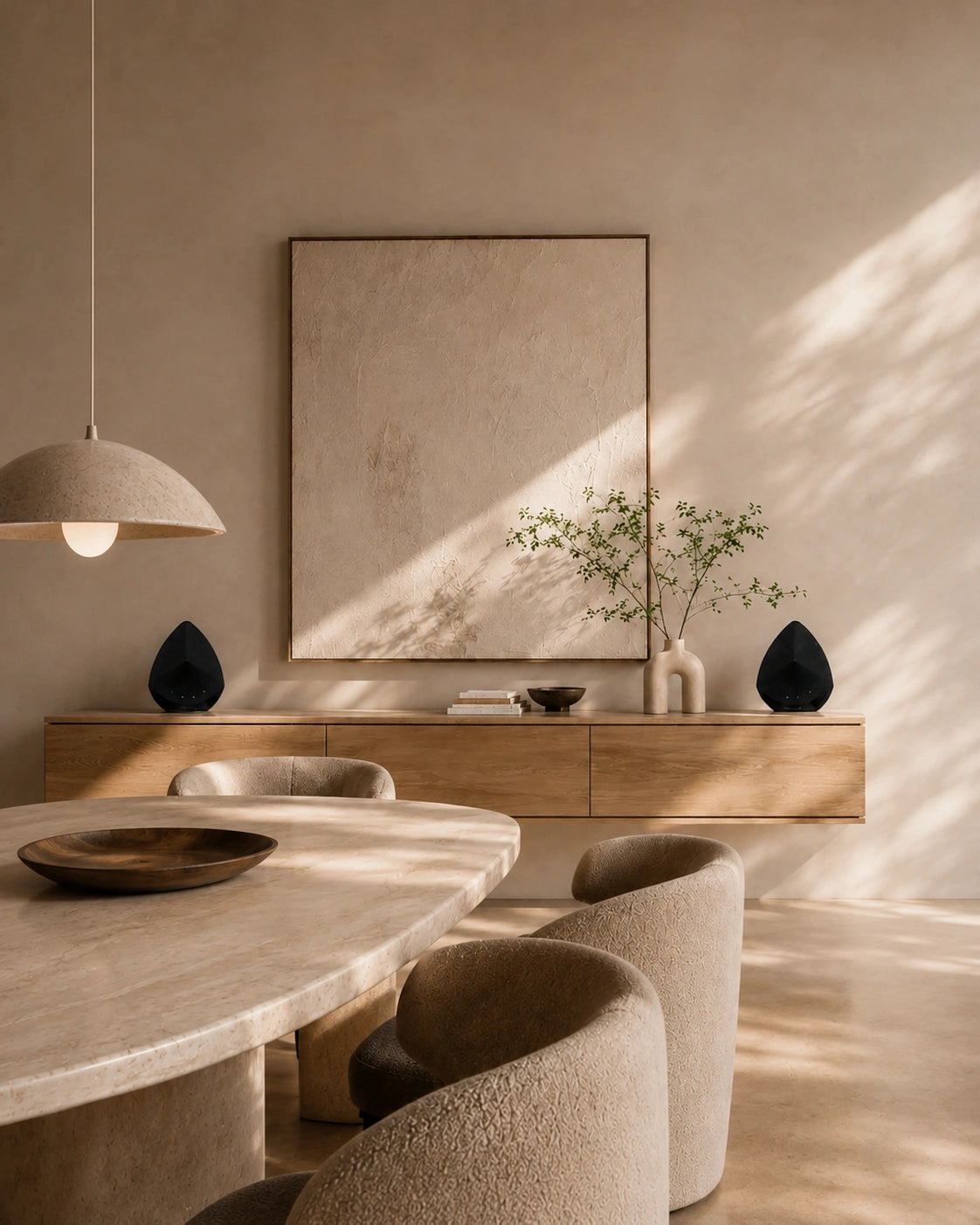 Modern dining room with marble table, wooden chairs, and neutral wall decor.