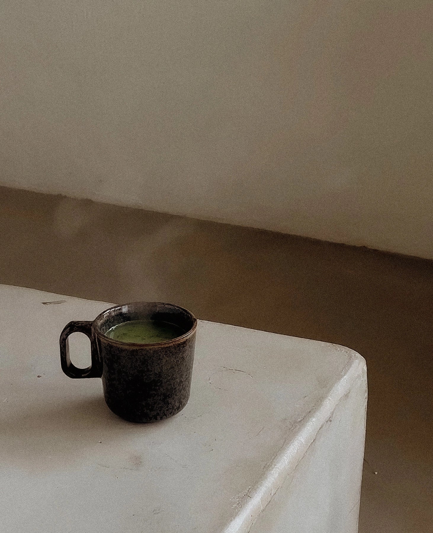 A cup of coffee on a concrete surface
