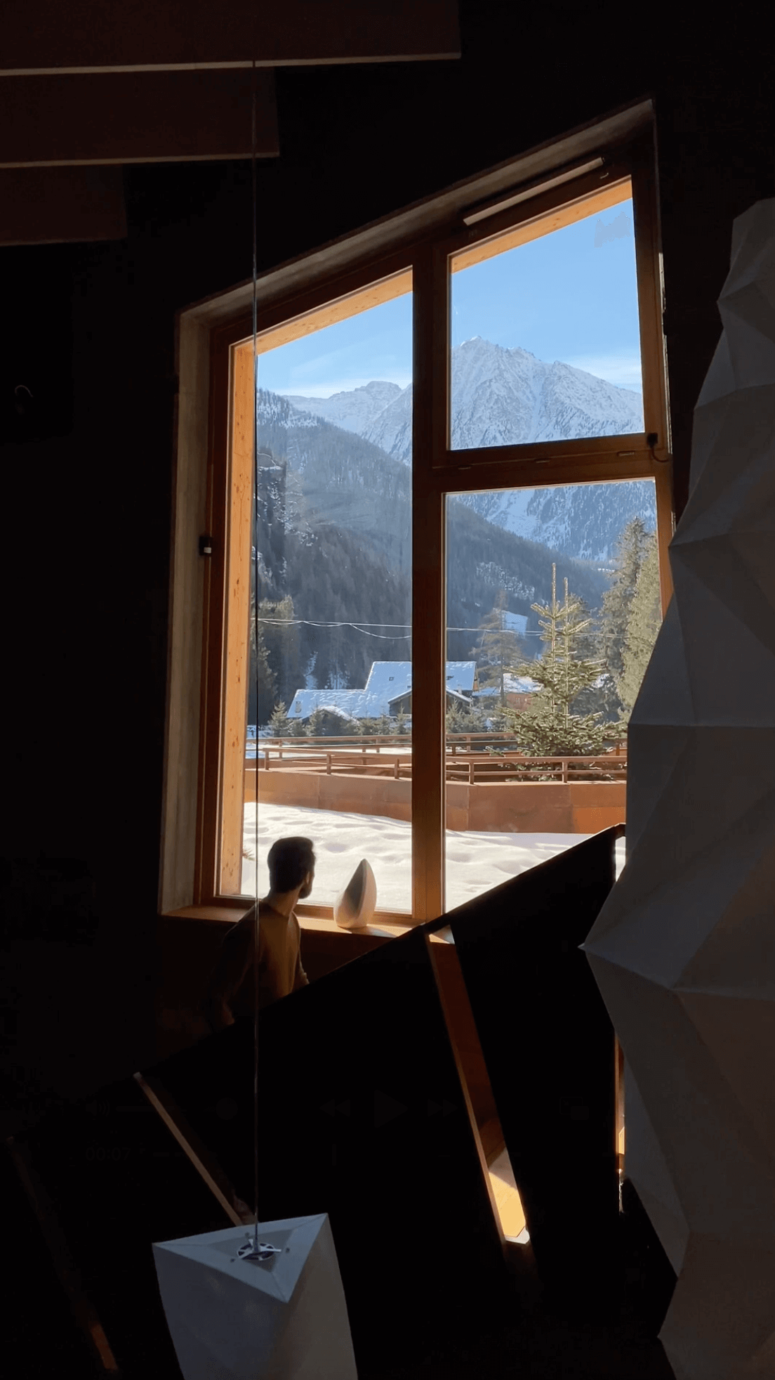 walking up the stairs looking at the obsidian speaker and the view