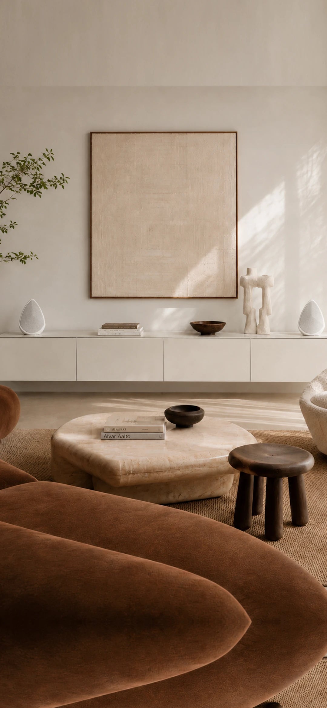 Modern living room with neutral tones, furniture, and decor.