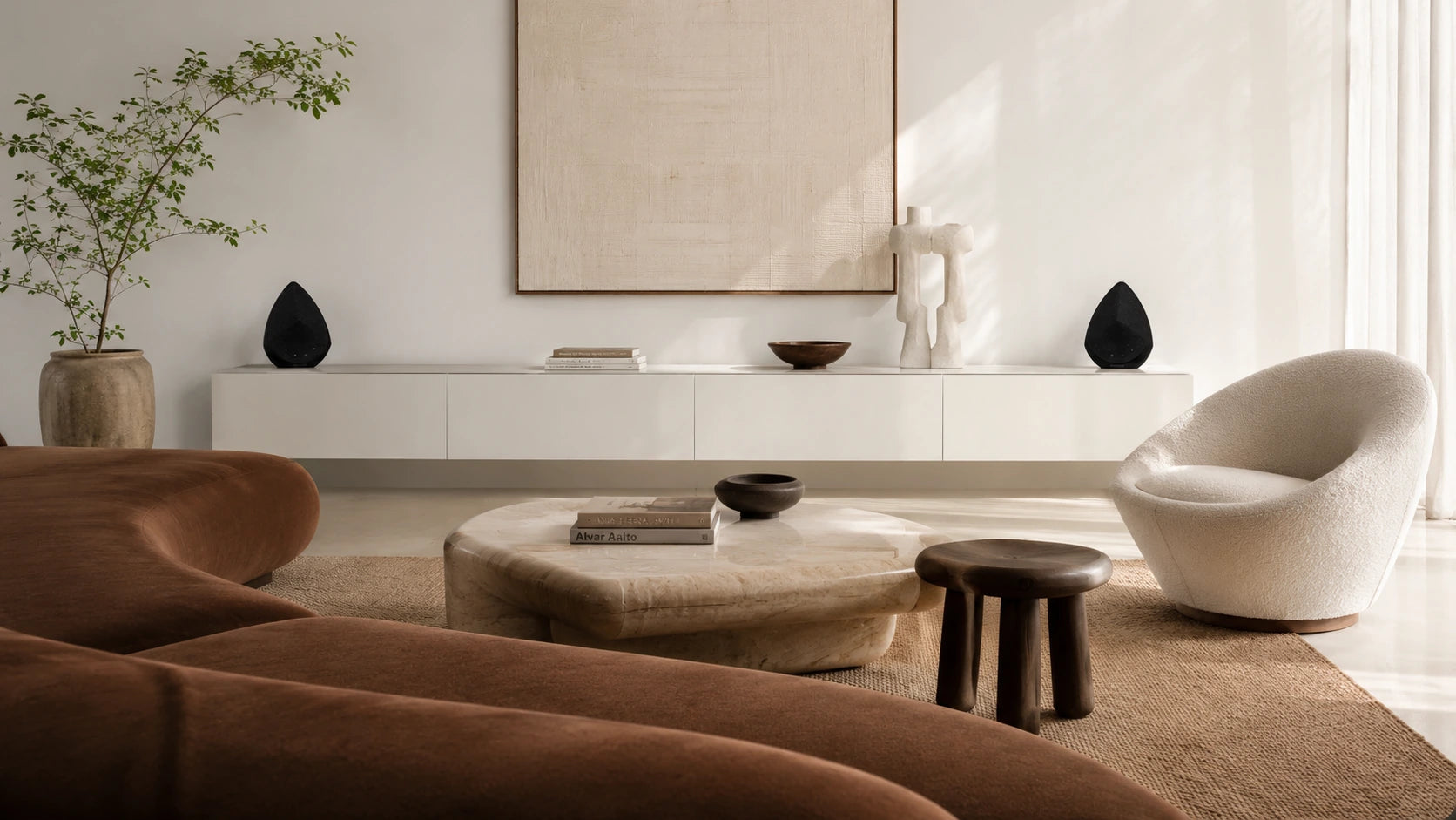 Modern living room with brown and white furniture, including a sofa and chair.