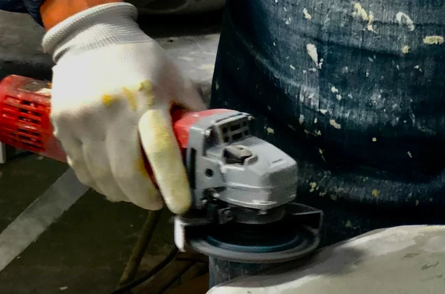 Maker smoothing the edge of a Pantheone resin speaker enclosure