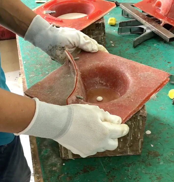 Gloved hands handling a mould for a Pantheone resin speaker enclosure