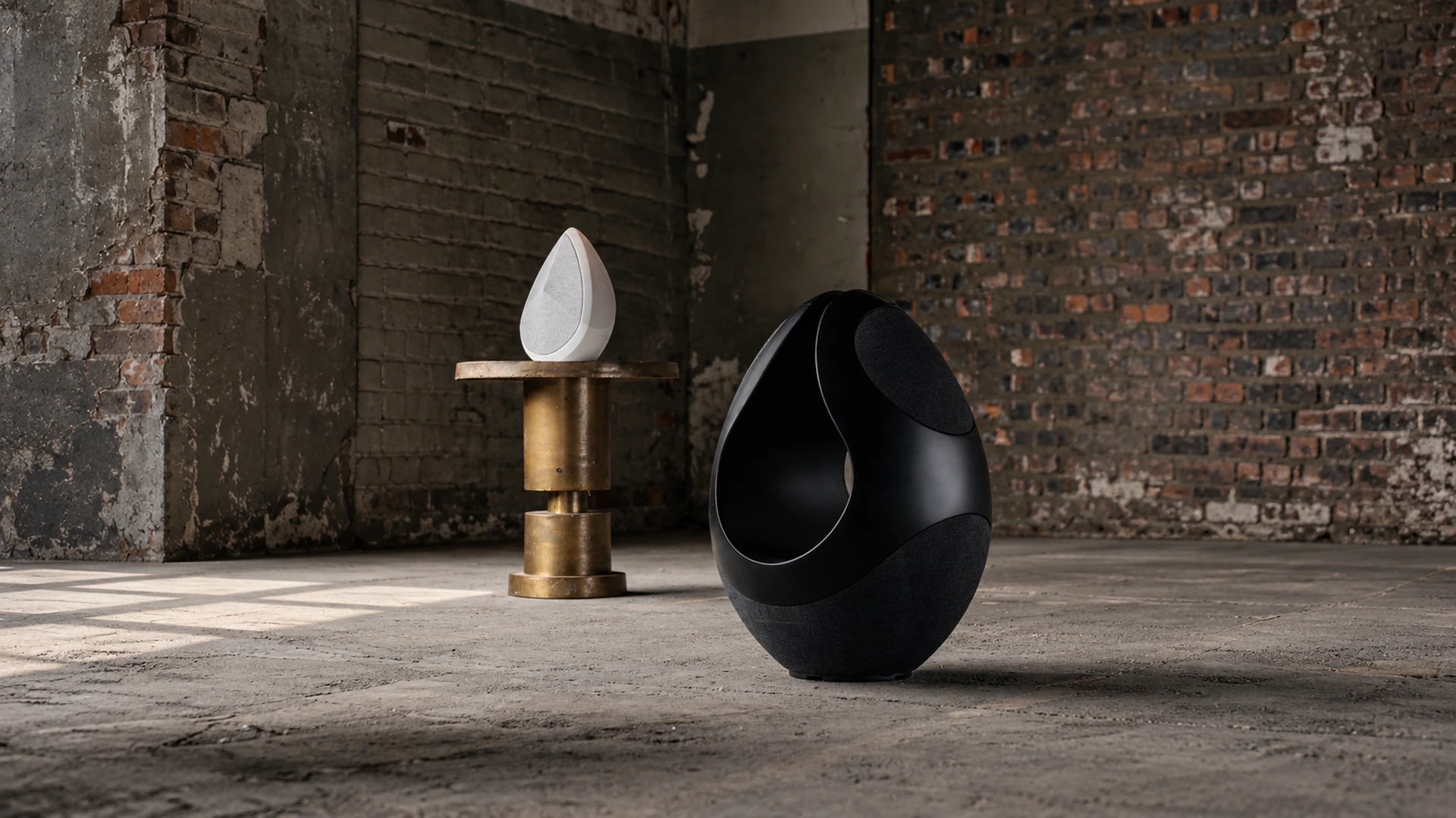 Pantheone I and Obsidian wireless speaker in an industrial space.
