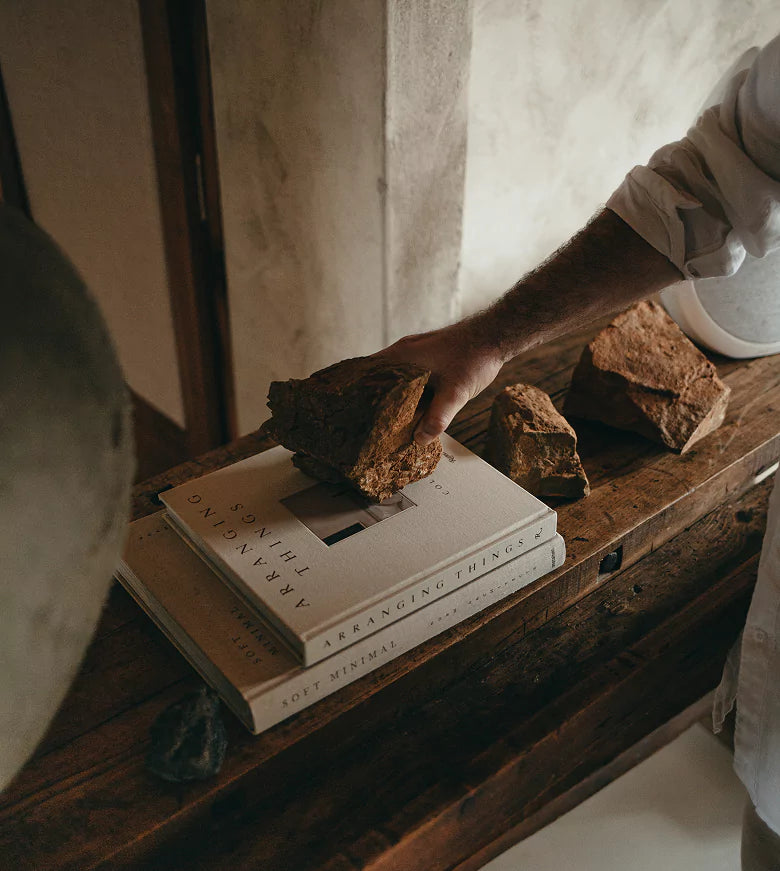 a man placing a stone on a book
