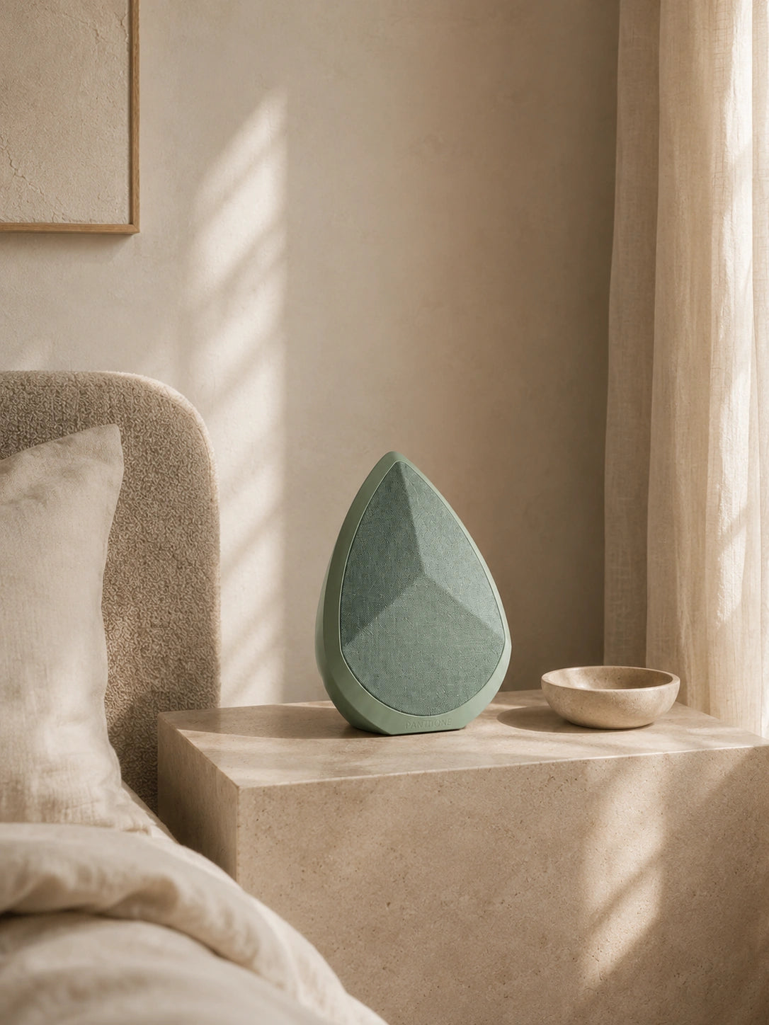 Decorative Obsidian Wireless speaker on a shelf in a softly lit room.